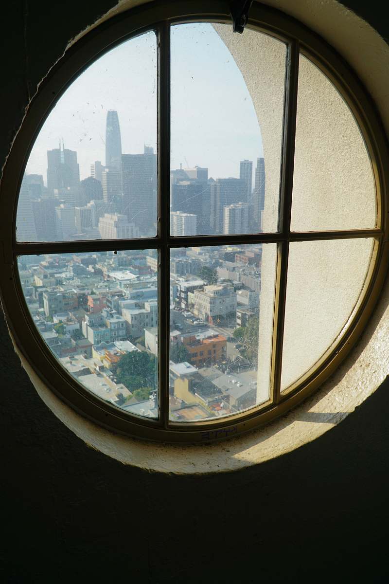 coit tower closed window viewing city with high-rise buildings san francisco
